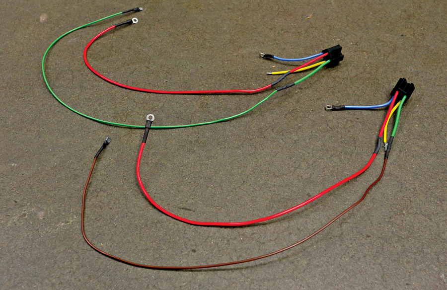 Each relay came with its own pigtail and plug. We just needed to extend the wires out for our use. Here, the red wires link to the breaker to feed main power to the relays. Blue is main ground for both, while green and brown are trigger wires, used to match the factory harness colors. Finally, yellow runs to the headlights.